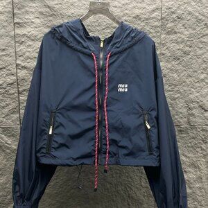 MIUMIU windbreaker, exquisitely tailored with a hood, combining workwear style w